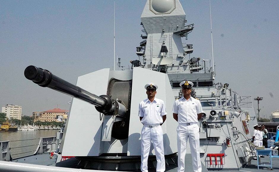 Naval officers stand near the 76 mm Super Rapid Gun Mount as they prepare for Wednesday's commissioning of INS Kochi into the Indian Navy, in Mumbai, India on September 28, 2015. Kochi is the second ship of the indigenously designed and constructed Project 15A (Kolkata-class) guided missile destroyer, built by Mazagon Dock Shipbuilders. INS Kochi incorporates new design concepts for stealth and has many firsts to her credit, including a very large component of indigenous combat-suite. The ship is packed with the most sophisticated state-of-the-art weapons and sensors including the vertically launched Long Range Surface to Air Missiles (LRSAM) and MF-STAR multi-function active phased array radar, which is fitted only on the Kolkata class of ships. She is equipped with the advanced supersonic and long range BrahMos Surface to Surface Missile - a joint Indo-Russian venture. The 76 mm Super Rapid Gun Mount (SRGM) and AK 630 CIWS, both manufactured indigenously, can take on air and surface targets. SOLARIS IMAGES