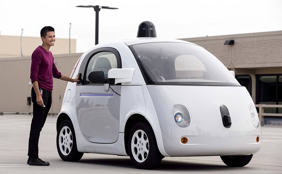 Google vehicle operator Reko Ong stands next to a prototype of Google's own self-driving vehicle during a media preview of Google's current autonomous vehicles in Mountain View, California September 29, 2015. REUTERS