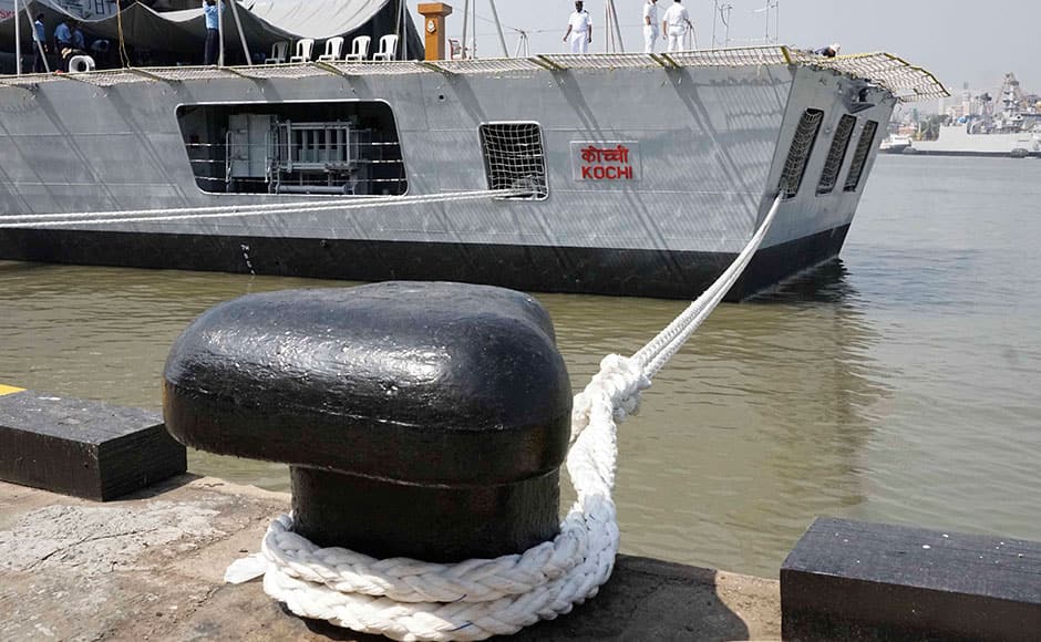 Naval officers stand near the 76 mm Super Rapid Gun Mount as they prepare for Wednesday's commissioning of INS Kochi into the Indian Navy, in Mumbai, India on September 28, 2015. Kochi is the second ship of the indigenously designed and constructed Project 15A (Kolkata-class) guided missile destroyer, built by Mazagon Dock Shipbuilders. INS Kochi incorporates new design concepts for stealth and has many firsts to her credit, including a very large component of indigenous combat-suite. The ship is packed with the most sophisticated state-of-the-art weapons and sensors including the vertically launched Long Range Surface to Air Missiles (LRSAM) and MF-STAR multi-function active phased array radar, which is fitted only on the Kolkata class of ships. She is equipped with the advanced supersonic and long range BrahMos Surface to Surface Missile - a joint Indo-Russian venture. The 76 mm Super Rapid Gun Mount (SRGM) and AK 630 CIWS, both manufactured indigenously, can take on air and surface targets. SOLARIS IMAGES