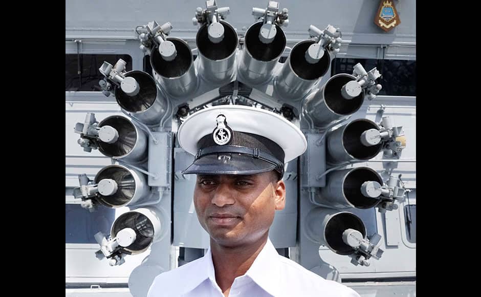 Naval officers stand near the 76 mm Super Rapid Gun Mount as they prepare for Wednesday's commissioning of INS Kochi into the Indian Navy, in Mumbai, India on September 28, 2015. Kochi is the second ship of the indigenously designed and constructed Project 15A (Kolkata-class) guided missile destroyer, built by Mazagon Dock Shipbuilders. INS Kochi incorporates new design concepts for stealth and has many firsts to her credit, including a very large component of indigenous combat-suite. The ship is packed with the most sophisticated state-of-the-art weapons and sensors including the vertically launched Long Range Surface to Air Missiles (LRSAM) and MF-STAR multi-function active phased array radar, which is fitted only on the Kolkata class of ships. She is equipped with the advanced supersonic and long range BrahMos Surface to Surface Missile - a joint Indo-Russian venture. The 76 mm Super Rapid Gun Mount (SRGM) and AK 630 CIWS, both manufactured indigenously, can take on air and surface targets. SOLARIS IMAGES