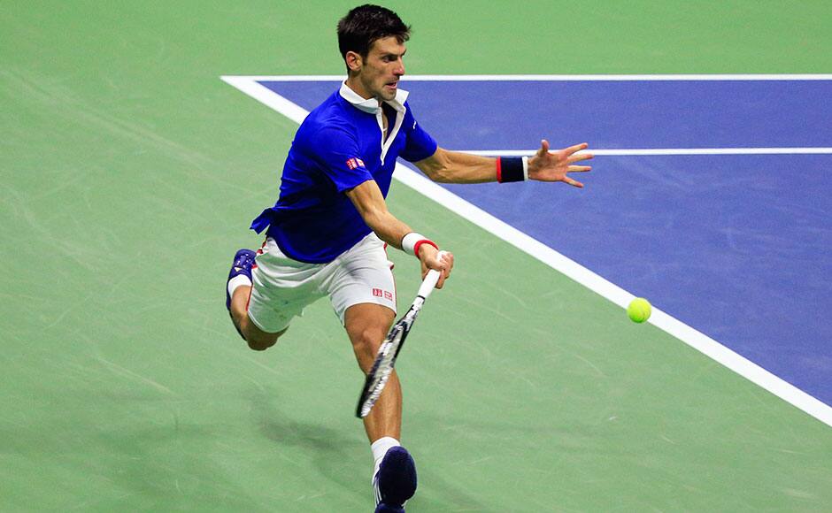 Novak Djokovic of Serbia chases down a return shot to Roger Federer of Switzerland during their men's singles final match at the U.S. Open Championships tennis tournament in New York, September 13, 2015. REUTERS