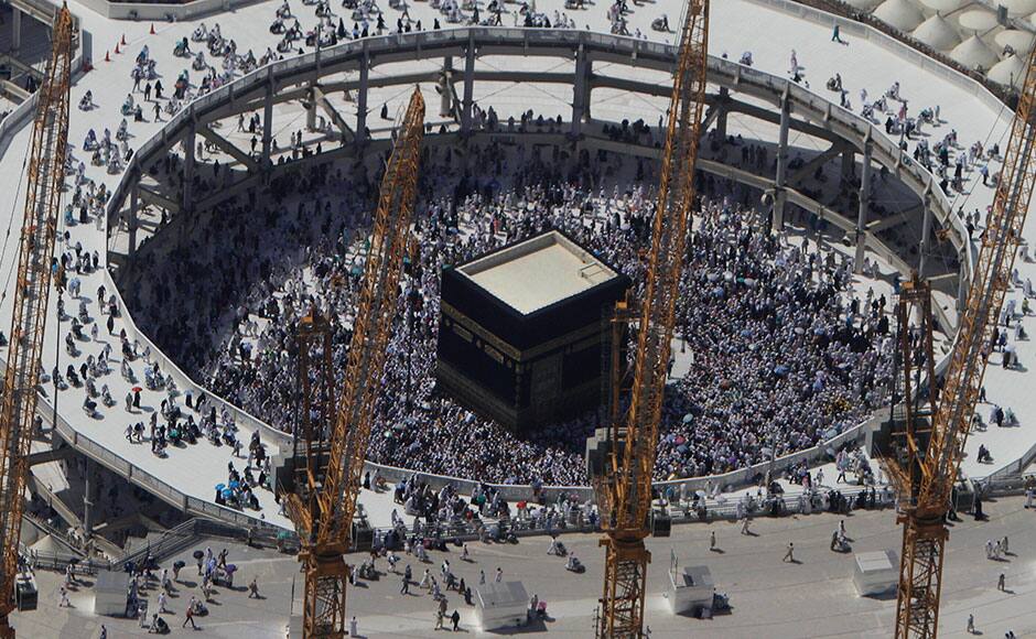 FILE - In this Wednesday, Oct. 16, 2013 file photo, cranes rise at the site of an expansion to the Grand Mosque as Muslim pilgrims circle counterclockwise around the Kaaba at the Grand Mosque in Mecca, Saudi Arabia. A towering construction crane toppled over on Friday, Sept. 11, 2015 during a violent rainstorm in the Saudi city of Mecca, Islam’s holiest site, crashing into the Grand Mosque and killing dozens of people ahead of the start of the annual hajj pilgrimage later this month.(AP Photo/Amr Nabil, File)