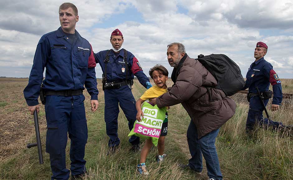 Hungarian camerawoman intentionally kicks, trips fleeing migrants
