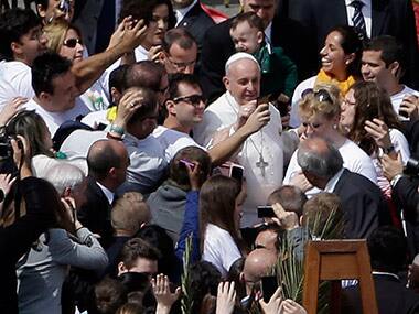 Pope Francis posing for selfies. AP 