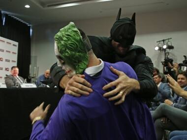 Tyson Fury, dressed as Batman tussles with someone dressed as The Joker during the press conference. Reuters