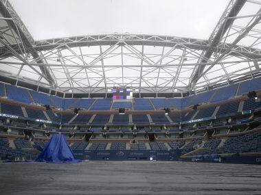 Arthur Ashe Stadium sits covered in rain tarps at the U.S. Open Championships tennis tournament. Reuters