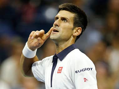 Novak Djokovic listens for the crowd reaction after breaking his opponent's serve. AP