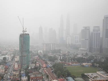 Malaysia's landmark building Petronas Twin Towers, center, and other buildings are shrouded by haze. AP