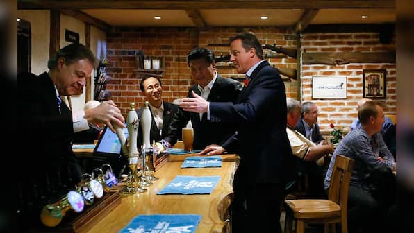 Bromance alert: PM Cameron takes President Xi to the pub for fish and chips