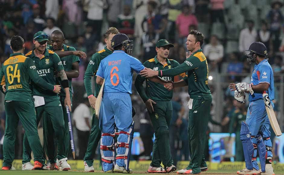 South African captain A.B. de Villiers, second right, greets India's Mohit Sharma after defeating India in the final one-day international cricket match of a five-game series in Mumbai, India, Sunday, Oct. 25, 2015. South Africa won by 214 runs to clinch the series 3-2.(AP Photo/Rajanish Kakade)