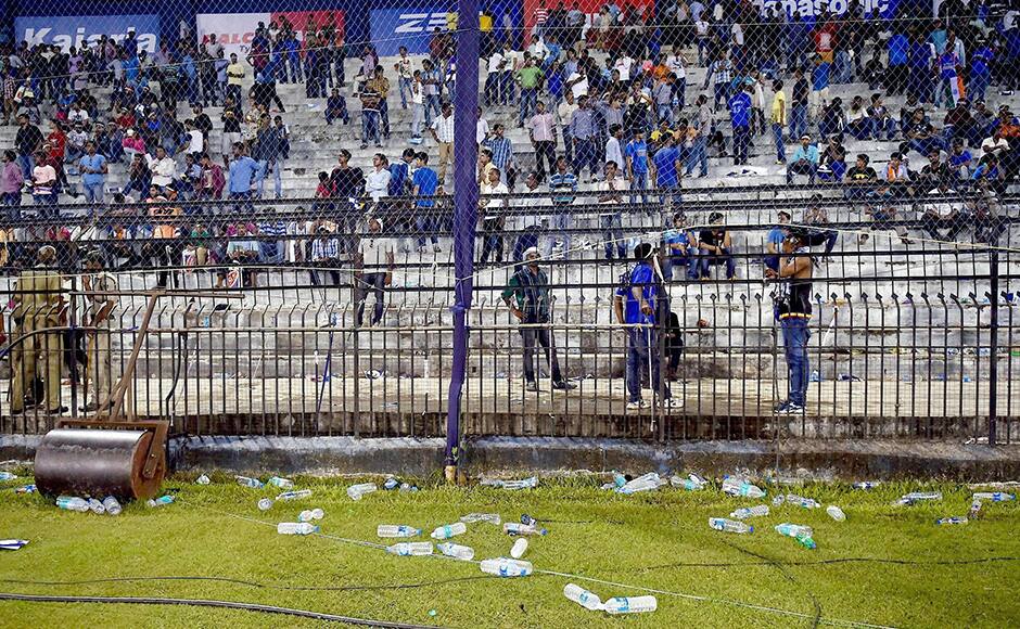 Water bottles thrown by spectators lie on the ground as the second Twenty20 cricket match between India and South Africa is disrupted in Cuttack, India, Monday, Oct. 5, 2015. (Swapan Mahapatra/Press Trust of India via AP)INDIA OUT