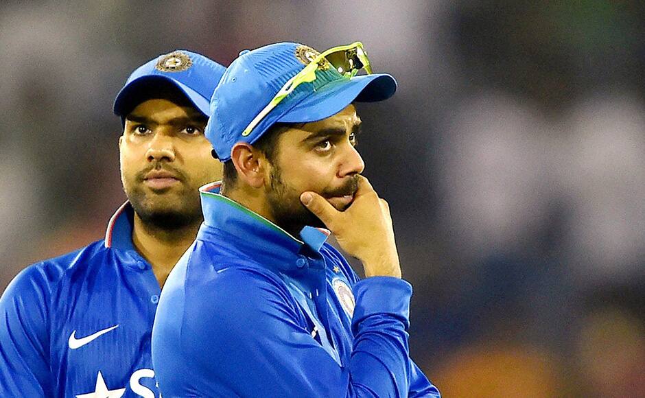 India's Virat Kohli and Rohit Sharma, left watche as their second Twenty20 cricket match against South Africa is disrupted after spectators threw water bottles in Cuttack, India, Monday, Oct. 5, 2015. (Swapan Mahapatra/Press Trust of India via AP)INDIA OUT
