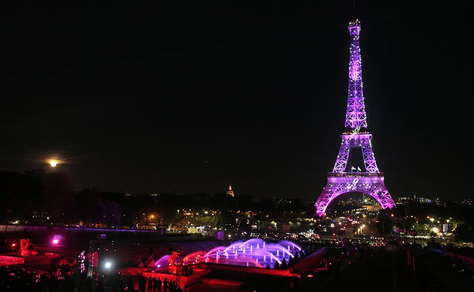 A picture taken on September 28, 2015 in Paris, shows the Eiffel Tower illuminated with a pink light, as part of the 'Ruban Rose' event launched by Paris' Mayor, during the 22nd campaign against breast cancer, in honor of National Breast Cancer Awareness Month, part of the Octobre Rose (Pink October). AFP PHOTO