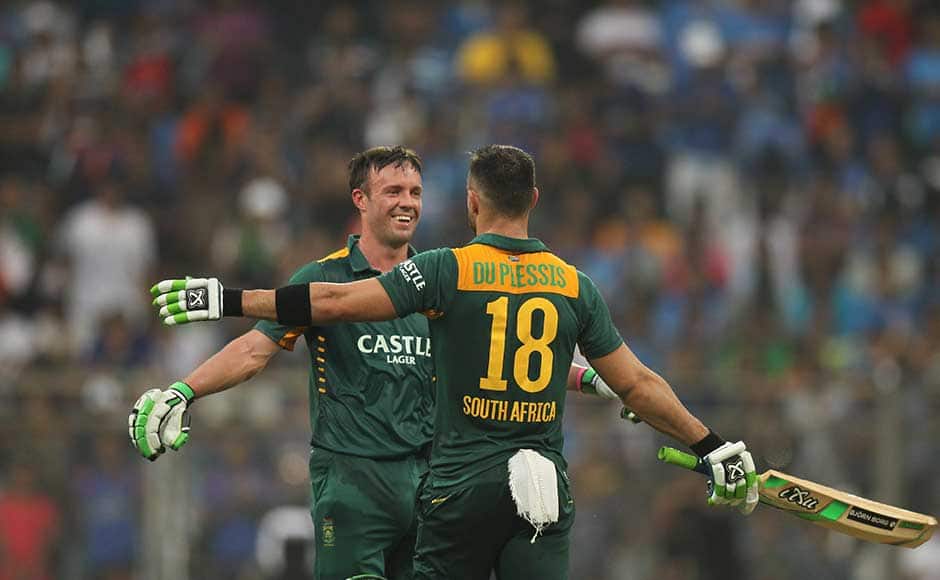 South Africa’s Faf du Plessis, back to camera celebrates his hundred runs with captain A.B. de Villiers, during the final one-day international cricket match of a five-game series against India in Mumbai, India, Sunday, Oct. 25, 2015. (AP Photo/Rafiq Maqbool)