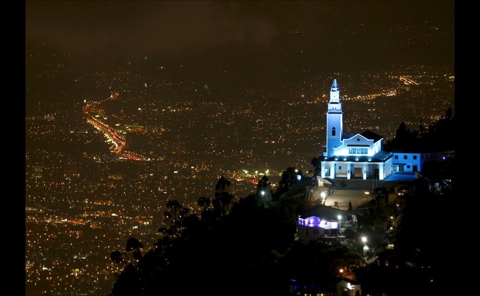Monserrate mountain and its church are pictured as the building is lit up in blue to honor the 70th anniversary of the United Nations in Bogota Monserrate mountain and its church are pictured as the building is lit up in blue to honor the 70th anniversary of the United Nations in Bogota