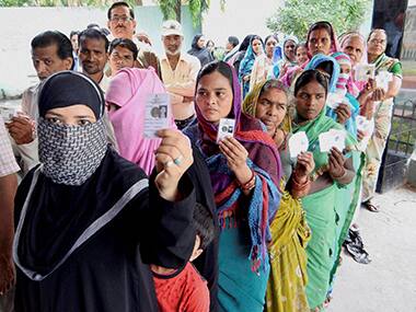 Voters wait to cast their ballot in Bihar. PTI