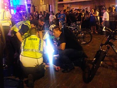 Emergency medical workers and police work next to a person at the scene of shooting at ZombiCon. AP