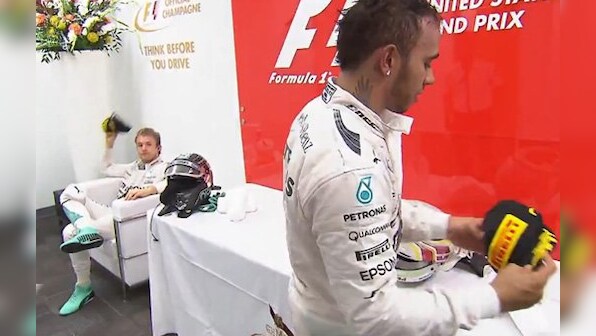 Awkward! 'Sour kraut' Nico Rosberg throws cap at Lewis Hamilton after losing the US Grand Prix