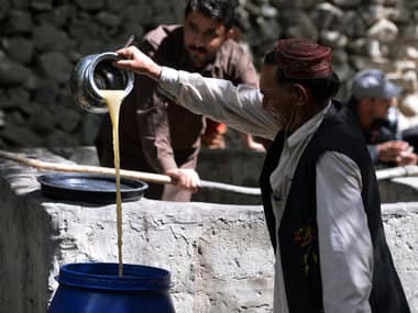 A local resident pours the juice from crushed grapes as part of a brewing wine process in a garden in the remote village of Sher Qilla in Punyal valley in northern Pakistan. AFP PHOTO / Aamir QURESHI