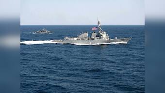 China warns US Navy after ship sails by Chinese-built island