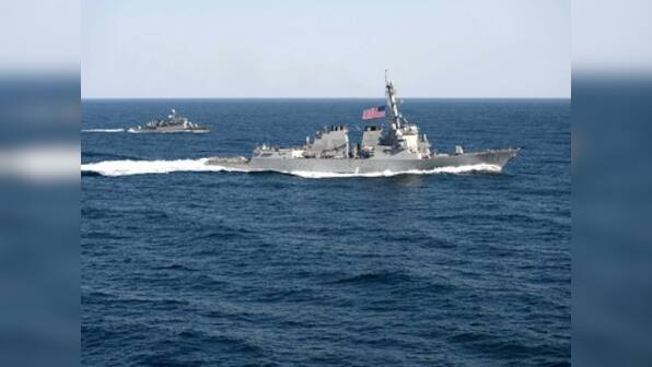 China warns US Navy after ship sails by Chinese-built island