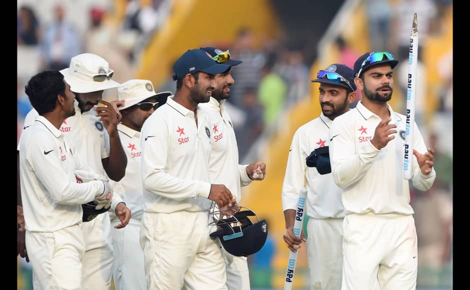 India's captain Virat Kohli (R) tosses a stump as Indian cricketers celebrate victory on the third day of the first Test match between India and South Africa at The Punjab Cricket Association Stadium in Mohali on November 7, 2015. India defeated South Africa by 108 runs in the first Test in Mohali to take the lead in the four-match series. AFP 