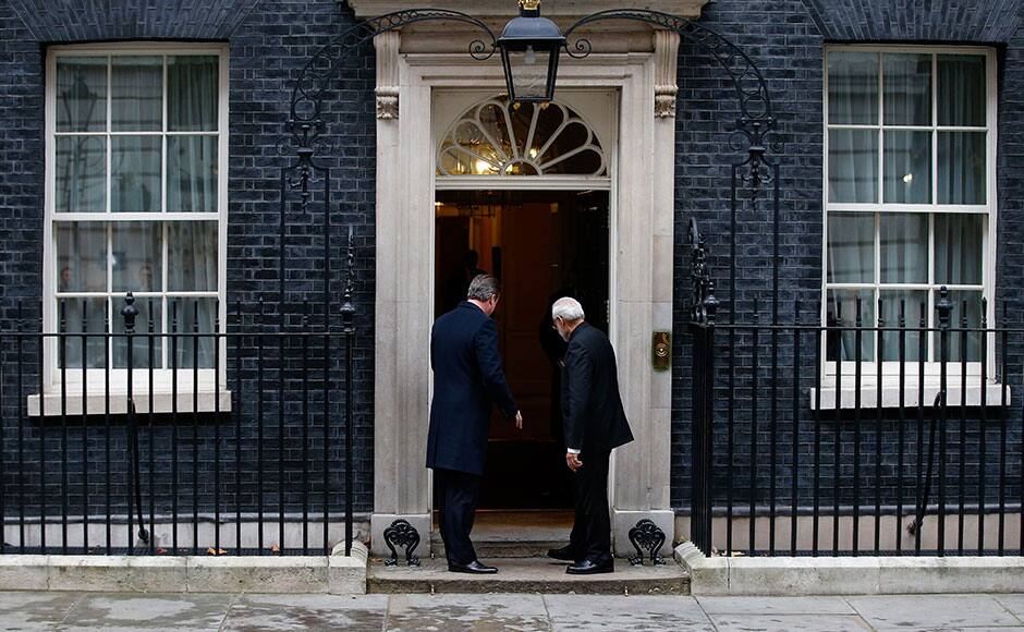 India's Prime Minister Narendra Modi's and Britain's Prime Minister David Cameron enter 10 Downing Street, in London, November 12, 2015. REUTERS