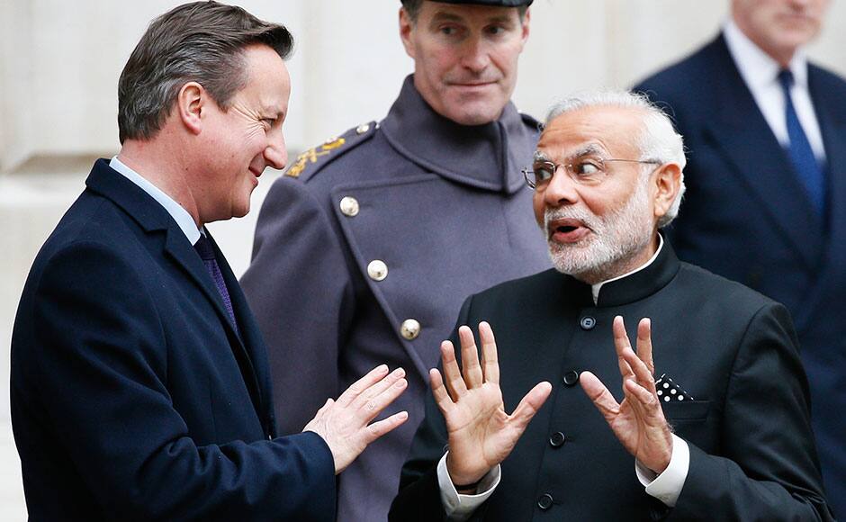 India's Prime Minister Narendra Modi's chats with Britain's Prime Minister David Cameron after the ceremonial welcome during his official visit, in London, November 12, 2015. REUTERS