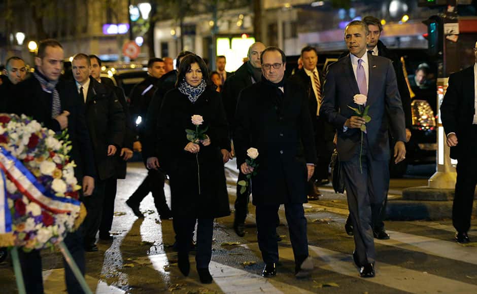 U.S. President Barack Obama, French President Francois Hollande and Paris Mayor Anne Hildago pay their respect at the Bataclan concert hall, one of the recent deadly Paris attack sites, after Obama arrived in the French capital to attend the World Climate Change Conference 2015 (COP21), November 30, 2015. REUTERS