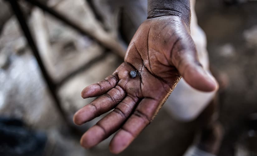 An illegal miner holds about one gram of white gold in a make-shift processing factory on the outskirts of Springs. AFP