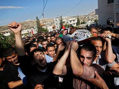Palestinian mourners carry the body of 22 year-old, Raed Jaradat, during his funeral in the West Bank village of Sa'ir, near Hebron on Nov 1, 2015. According to the Israeli army, Jaradat stabbed an Israeli before being shot and killed. AP 