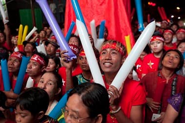 Supporters of Myanmar opposition leader Aung San Suu Kyis National League for Democracy party cheer as they watch the results of the general election on an LED screen displayed outside the party's headquarters. AP 