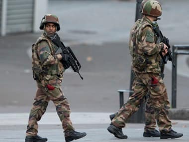 French soldiers patrol during a raid in Saint-Denis. AP 