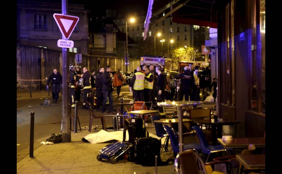 A general view of the scene that shows rescue services near the covered bodies outside a restaurant following a shooting incident in Paris, France, November 13, 2015. REUTERS