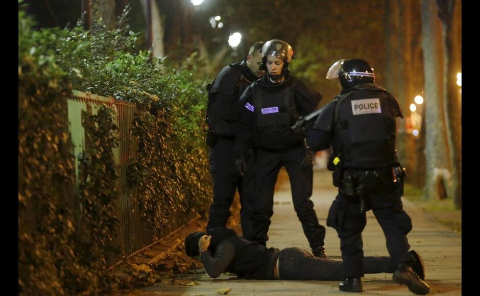 A man lies on the ground as French police check his identity near the Bataclan concert hall following fatal shootings in Paris, France, November 13, 2015. The man was later released after his identity was verified. REUTERS/Christian Hartmann TPX IMAGES OF THE DAY - RTS6WAE