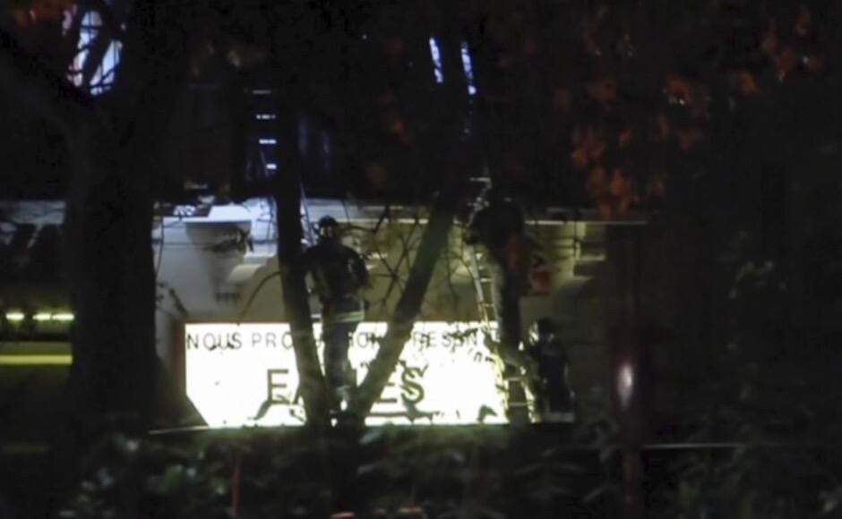 French firefighters climb ladders to rescue hostages as security forces carry out an assault at the Bataclan concert hall, in Paris, France, in this still image taken from video November 14, 2015. Gunmen and bombers attacked restaurants, a concert hall and a sports stadium at locations across Paris on Friday, killing at least 120 people in what a shaken President Francois Hollande called an unprecedented terrorist attack. REUTERS/Reuters TV - RTS6XCV