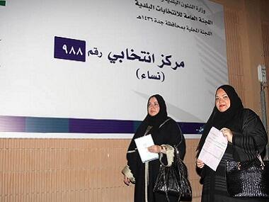Saudi women hold applications as they head to register to vote in the port city of Jeddah on 30 August. AFP 