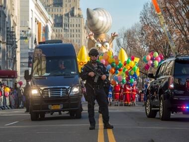Armed NYPD officers at the NYC Thanksgiving parade/ AP