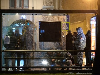 Russian police investigators inspect a damaged bus stop in a blast on Pokrovka street in central Moscow. AFP 