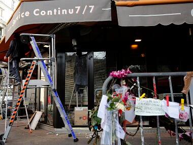 Men work on the shop front of the cafe 