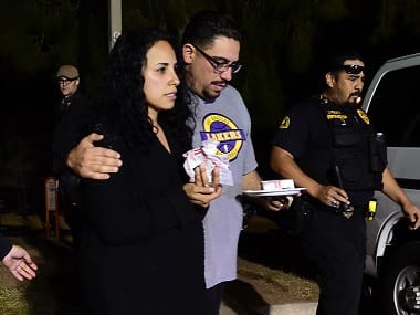 Omar Riopedre embraces his wife Diana, who was in the Inland Regional Center when the mass shootings took place. AFP 