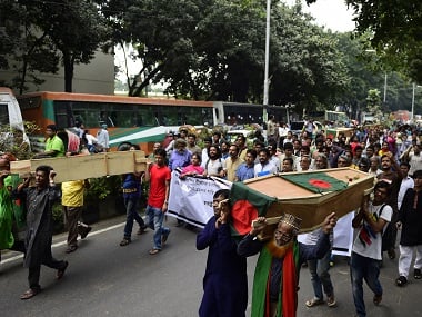 Bangladeshi activists shout slogans as they march in the street with mock coffins, that symbolize the deaths of secular publishers and bloggers, in Dhaka on November 5, 2015. AFP 