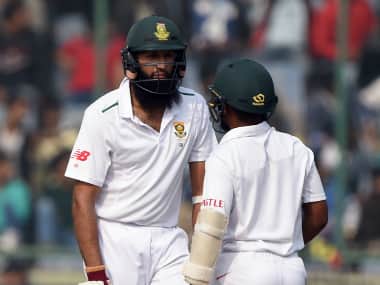 South Africa’s captain Hashim Amla (L) talks with South Africa’s Temba Bavuma during the fourth day of the fourth Test. AFP