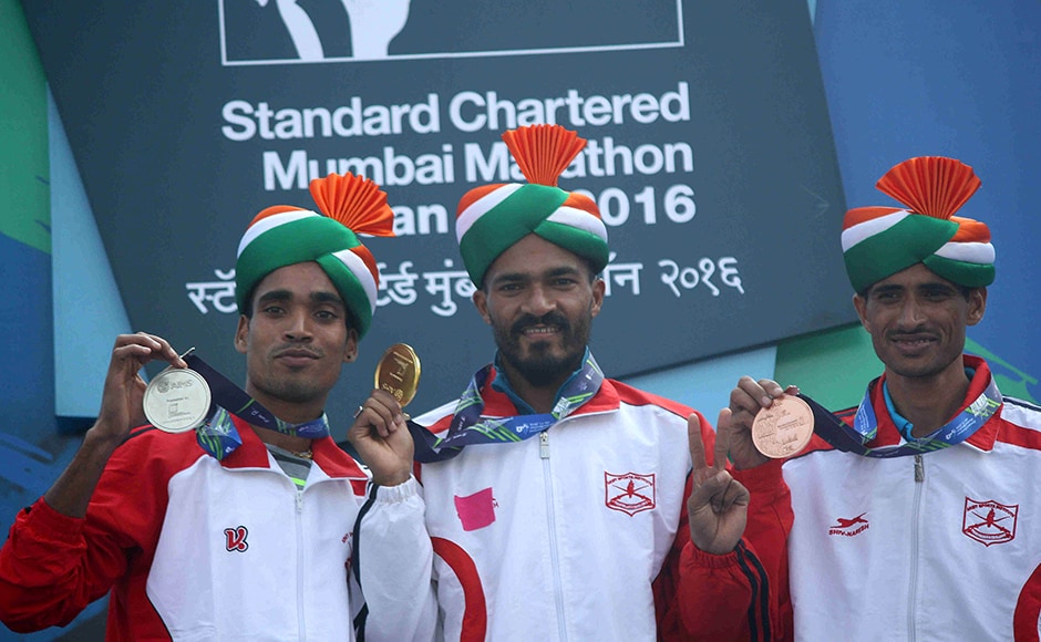 (L to R) Indian athletes Gopi T, Nitenrra Singh Rawat and Kheta Ram hold their medals after the Standard Chartered Mumbai Marathon 2016 in Mumbai, India on January 17, 2016. (Pravin Utturkar/SOLARIS IMAGES)