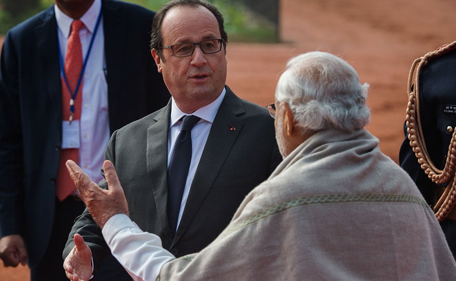 French President Francois Hollande gestures as he says goodbye to Indian Prime Minister Narendra Modi at the end of Hollande's welcoming ceremony in New Delhi on January 25, 2016. After beginning a three-day visit to India in the northern city of Chandigarh on January 24, French President Francois Hollande has headed to the capital New Delhi to make common cause with India's Prime Minister Narendra Modi on issues such as combating Islamist extremists and climate change. AFP PHOTO /ROBERTO SCHMIDT