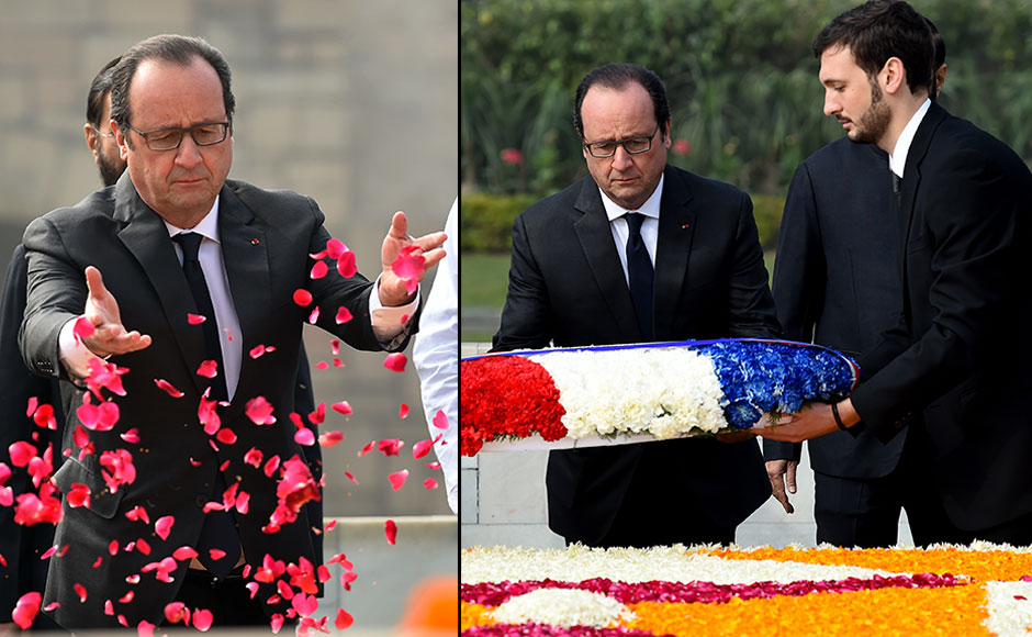 French President Francois Hollande (C) throws rose petals as he pays tribute at Raj Ghat -- the memorial to the father of the Indian nation Mahatma Gandhi -- in New Delhi on January 25, 2016. After beginning a three-day visit to India in the northern city of Chandigarh on January 24, French President Francois Hollande has headed to the capital New Delhi to make common cause with India's Prime Minister Narendra Modi on issues such as combating Islamist extremists and climate change. AFP PHOTO / Money SHARMA