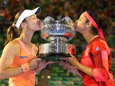 Martina Hingis of Switzerland and Sania Mirza of India pose with the championship trophy after winning their women's doubles final. Getty
