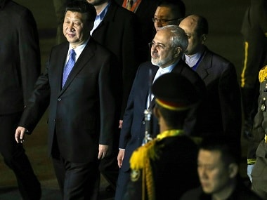 Iranian Foreign Minister Javad Zarif welcomes Chinese President Xi Jinping upon his arrival in Tehran. AP