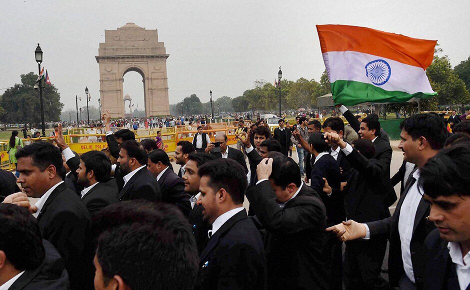 New Delhi: Lawyers carry a Tricolour as they march from Patiala House Courts to India Gate against alleged anti-national activities at JNU, in New Delhi on Friday. PTI Photo by Atul Yadav
