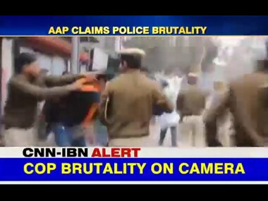 Policemen in Delhi beat up student protesters. Screenshot from IBNLive video.
